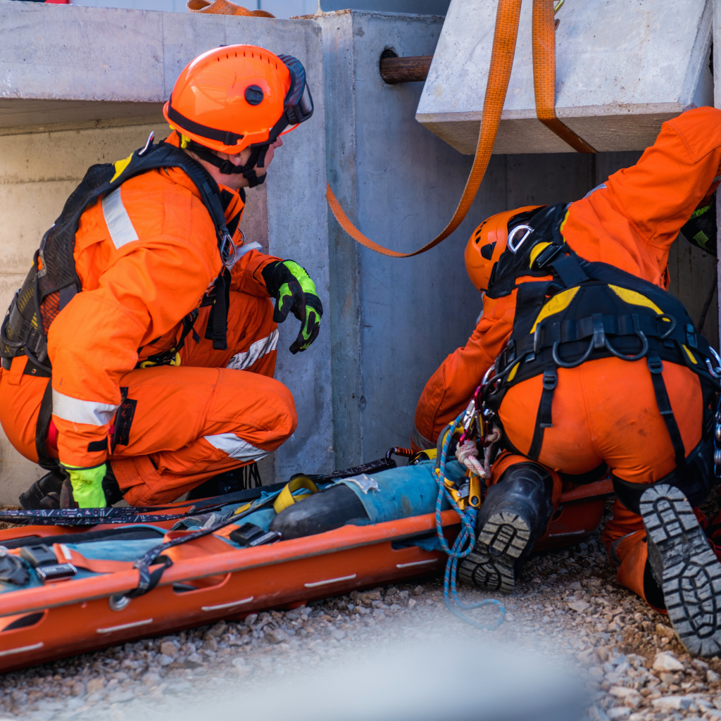 uetdrel006 workers using rescue board on the ground